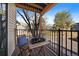 Cozy balcony with a wooden table, chair and decor, perfect for outdoor relaxation and enjoying the view at 6011 Yarrow St # C, Arvada, CO 80004