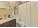 Traditional bathroom featuring a vanity with dark wood cabinets and a white shower curtain at 6011 Yarrow St # C, Arvada, CO 80004