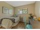 This bedroom has neutral paint, updated floors, and a small desk at 6011 Yarrow St # C, Arvada, CO 80004