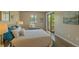 Comfortable bedroom features slider to private deck and bench under the window at 6011 Yarrow St # C, Arvada, CO 80004
