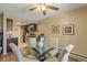Charming dining area with a glass table, upholstered chairs, and adjacent kitchen space at 6011 Yarrow St # C, Arvada, CO 80004