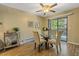 Bright dining area with a glass table, comfortable chairs, and a sliding door to outdoor balcony at 6011 Yarrow St # C, Arvada, CO 80004