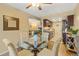 Open concept dining area leading to kitchen and living room with glass table and seating for four at 6011 Yarrow St # C, Arvada, CO 80004