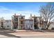 Exterior view of two-story condos with balconies and staircases, showcasing the architecture and design under a blue sky at 6011 Yarrow St # C, Arvada, CO 80004