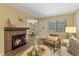 Cozy living room featuring tile fireplace, bright lighting, and lots of natural light at 6011 Yarrow St # C, Arvada, CO 80004