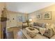 Comfortable living room with a decorative fireplace, hardwood floors and lots of light at 6011 Yarrow St # C, Arvada, CO 80004