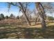 Scenic park view with mature trees and grassy areas, offering a peaceful retreat in nature at 6011 Yarrow St # C, Arvada, CO 80004