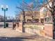 Charming town entrance with brick design and clear signage; lovely light posts at 6011 Yarrow St # C, Arvada, CO 80004