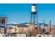 View of a water tower with mountains in the background, against a blue sky at 6011 Yarrow St # C, Arvada, CO 80004