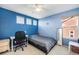 This bedroom is bright and blue with a ceiling fan and a neutral carpet at 22668 E Lake Pl, Centennial, CO 80015