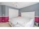 The bedroom offers a white paneled bed frame, storage on either side, and colorful, patterned walls at 22668 E Lake Pl, Centennial, CO 80015