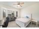 Serene bedroom boasts a window seat and plenty of natural light with light hardwood flooring at 22668 E Lake Pl, Centennial, CO 80015