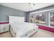 This bedroom includes a chandelier, a bed with storage, a colorful accent wall, and a window seat at 22668 E Lake Pl, Centennial, CO 80015