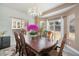 The formal dining room has a large table set under a decorative chandelier with backyard views at 22668 E Lake Pl, Centennial, CO 80015