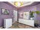 An elegant dining area features purple walls, unique tile floors, and contemporary decor at 22668 E Lake Pl, Centennial, CO 80015