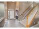 Bright foyer with hardwood floors, staircase, and an arched entryway, creating a welcoming entrance at 22668 E Lake Pl, Centennial, CO 80015