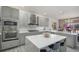 Stylish kitchen showcases a central island with seating and views into the formal dining room at 22668 E Lake Pl, Centennial, CO 80015