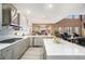 Bright and spacious kitchen features a large island and breakfast bar with stainless appliances at 22668 E Lake Pl, Centennial, CO 80015