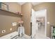 Functional laundry room has neutral walls, a countertop area, and a view to the kitchen at 22668 E Lake Pl, Centennial, CO 80015