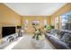 Bright living room offers a comfy sofa, exercise bike, and an abundance of natural light at 22668 E Lake Pl, Centennial, CO 80015