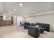 Expansive living room with plush black leather seating and recessed lighting, ideal for relaxing and entertaining at 22668 E Lake Pl, Centennial, CO 80015