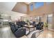 Bright living room with high ceilings, large windows, and comfortable leather seating, perfect for relaxation at 22668 E Lake Pl, Centennial, CO 80015
