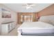 Spacious main bedroom showcases a large bed, white dresser, neutral walls, and a decorative window with golden curtains at 22668 E Lake Pl, Centennial, CO 80015