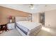 The main bedroom is bright with a plush bed, neutral walls, and a white nightstand with flowers at 22668 E Lake Pl, Centennial, CO 80015