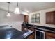 Stylish wet bar with dark countertops, modern appliances, and accent lighting, perfect for entertaining guests at 22668 E Lake Pl, Centennial, CO 80015