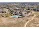 Aerial view of a community clubhouse and pool, highlighting community amenities and walking path at 6880 S Yantley Ct, Aurora, CO 80016