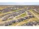 Expansive aerial view of a well-planned community showcasing neat rows of homes and landscaped common areas at 6880 S Yantley Ct, Aurora, CO 80016