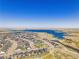 Overhead view of a community near a lake, highlighting the neighborhood's layout and recreational water access at 6880 S Yantley Ct, Aurora, CO 80016