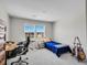 Bedroom with a desk, a comfortable bed, a view to the outside and instruments for music lovers at 6880 S Yantley Ct, Aurora, CO 80016