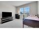 Bright bedroom featuring large windows, neutral walls, and a comfortable bed with a minimalist decor at 6880 S Yantley Ct, Aurora, CO 80016