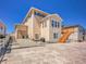 Stunning two-story home featuring a large stamped patio and a private exterior stairwell at 6880 S Yantley Ct, Aurora, CO 80016