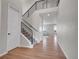 Bright foyer with hardwood floors, a staircase with iron railings, and views into the living area at 6880 S Yantley Ct, Aurora, CO 80016