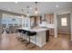 Gourmet kitchen with stainless steel appliances, a large island with seating, and modern pendant lighting at 6880 S Yantley Ct, Aurora, CO 80016