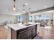 Elegant kitchen island with pendant lights, stainless steel appliances, and an open dining area nearby at 6880 S Yantley Ct, Aurora, CO 80016