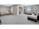 Spacious living room with plush carpeting, large windows, and comfortable seating arrangements at 6880 S Yantley Ct, Aurora, CO 80016