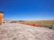 Large concrete patio perfect for outdoor activities with scenic views of the nearby field and lake at 6880 S Yantley Ct, Aurora, CO 80016