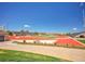 Expansive stadium with a vibrant red track field, lush green turf, and ample seating under a clear blue sky at 6880 S Yantley Ct, Aurora, CO 80016