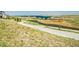 Scenic community walking path leading towards a picturesque pond, highlighting outdoor recreational opportunities at 6880 S Yantley Ct, Aurora, CO 80016