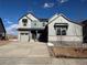 Two-story house with gray siding, stone accents, and a two-car garage at 2904 S Poppy St, Morrison, CO 80465
