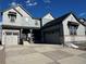 Two-story house with gray siding, stone accents, and a two-car garage at 2904 S Poppy St, Morrison, CO 80465