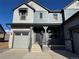 Two-story house with gray siding, stone accents, and a two-car garage at 2904 S Poppy St, Morrison, CO 80465