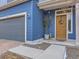 Home exterior showcasing the attached garage, front door, and well-maintained landscaping at 17950 E 54Th Ave, Denver, CO 80249