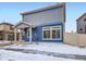 Side view of home with blue siding, white trim, and snow-covered yard at 17950 E 54Th Ave, Denver, CO 80249