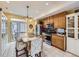 Modern kitchen with stainless steel appliances, breakfast bar seating, and sliding glass door at 17950 E 54Th Ave, Denver, CO 80249