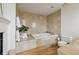 Bathroom with a soaking tub and elegant tile work, complemented by hardwood flooring at 2000 Little Raven St # 4A, Denver, CO 80202