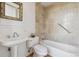Bathroom featuring a pedestal sink and a tiled shower-tub combination at 2000 Little Raven St # 4A, Denver, CO 80202